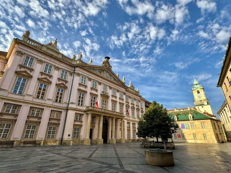 Stunning view of the Primate's Palace in Bratislava's Old Town, featuring its elegant neoclassical architecture under a beautiful blue sky