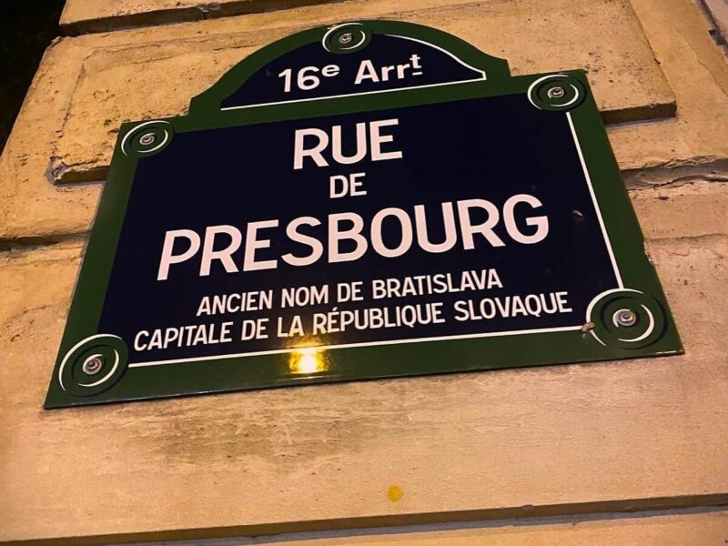 Bratislava and Paris, A street sign in the 16th arrondissement of Paris labeled "Rue de Presbourg," noting that Presbourg was the former name of Bratislava, the capital of the Slovak Republic. The sign has a traditional French street design, mounted on a beige stone wall.