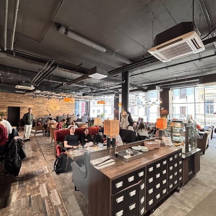 Martinus Bookstore Café in Bratislava with customers enjoying coffee among books and a creative ambiance