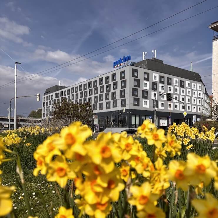 Park Inn by Radisson Danube Hotel Bratislava exterior view with yellow daffodils in sprin