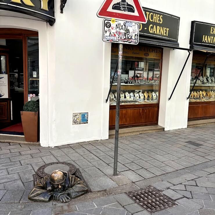 Čumil bronze statue emerging from a manhole cover in Bratislava Old Town — one of the most iconic hidden gems to discover during 48 hours in Bratislava