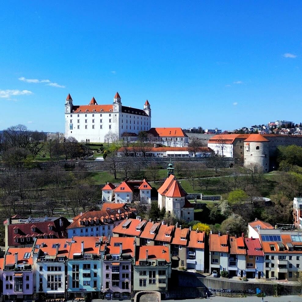 Aerial drone view of Bratislava Castle above the castle district and Danube embankment — the must-see landmark when spending 48 hours in Bratislava