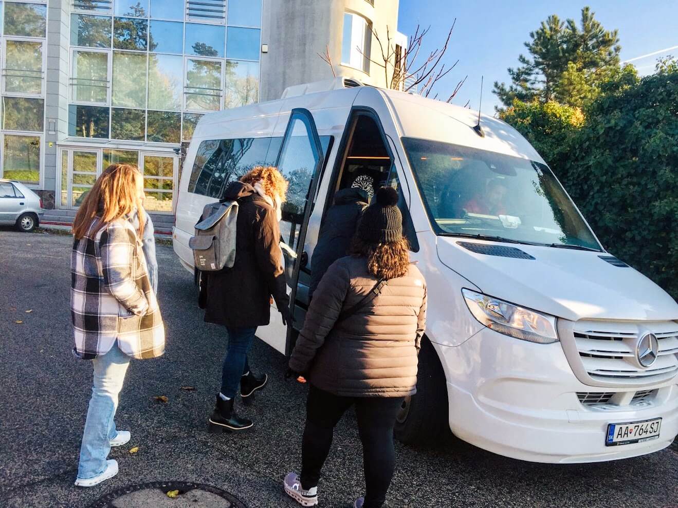 Tourists boarding a private Mercedes Sprinter van for a Bratislava city tour