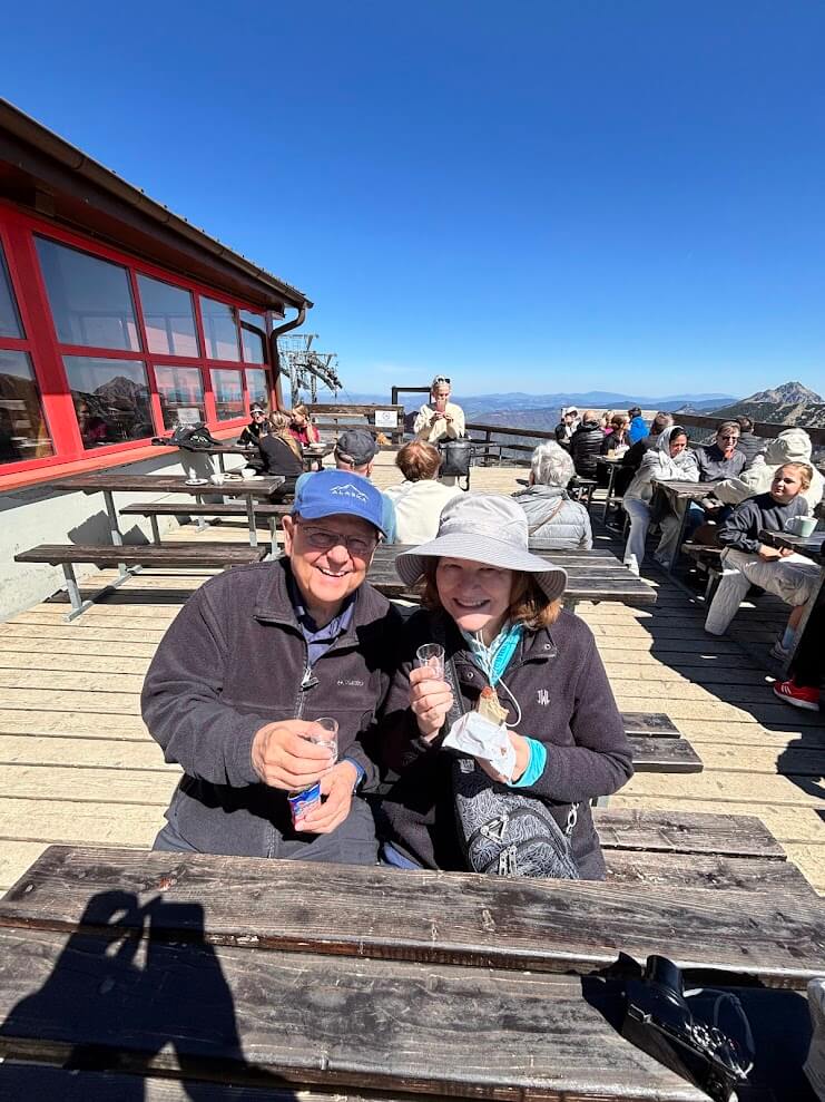 Couple enjoying a drink on the mountain terrace at Snilovské Peak in Vrátna Valley, Small Fatra National Park — full-day trip from Bratislava