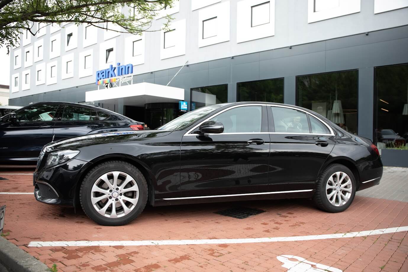 Bratislava Mercedes E class car posing in front of hotel park Inn Bratislava