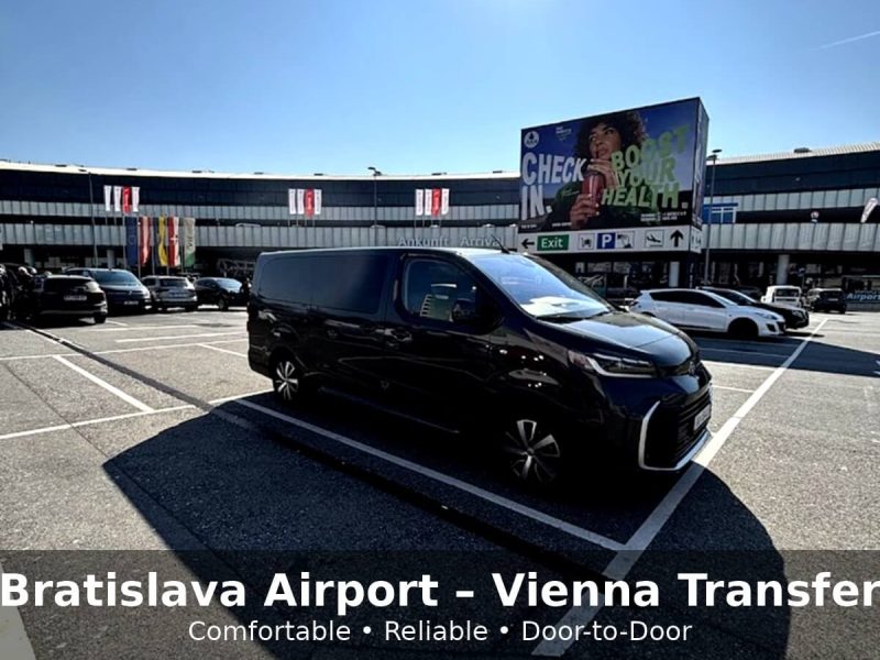 Black private transfer van parked outside Vienna Airport terminal, promoting a comfortable and reliable door-to-door transfer service between Bratislava Airport and Vienna.
