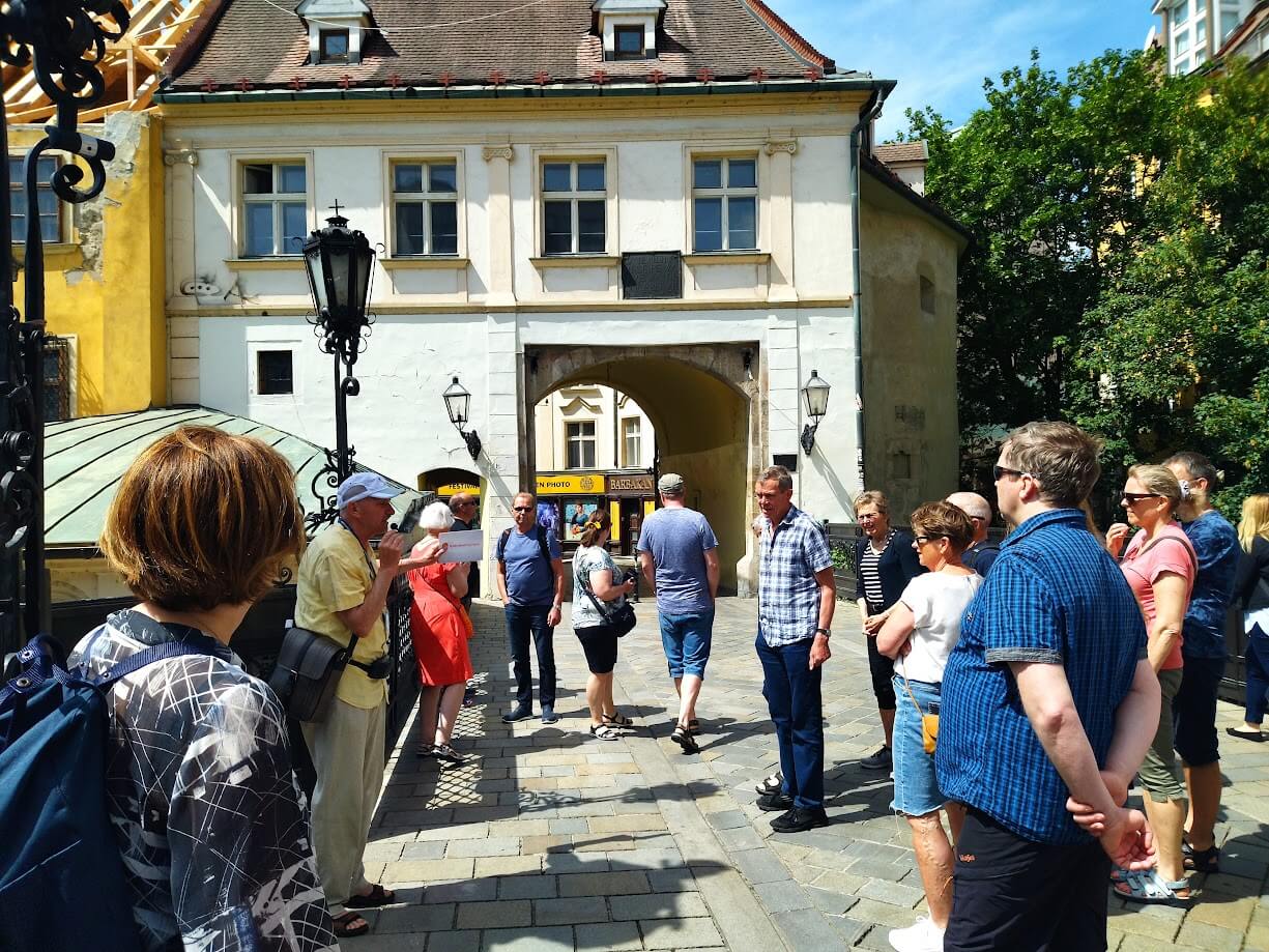 Guided tour group at Michael's Gate in Bratislava before travelling the Bratislava to Budapest distance